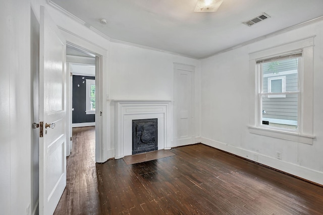 unfurnished living room with dark wood-type flooring, healthy amount of natural light, a fireplace with flush hearth, crown molding, and baseboards