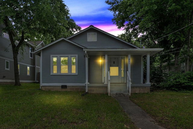 bungalow-style home featuring crawl space, a front yard, and a porch