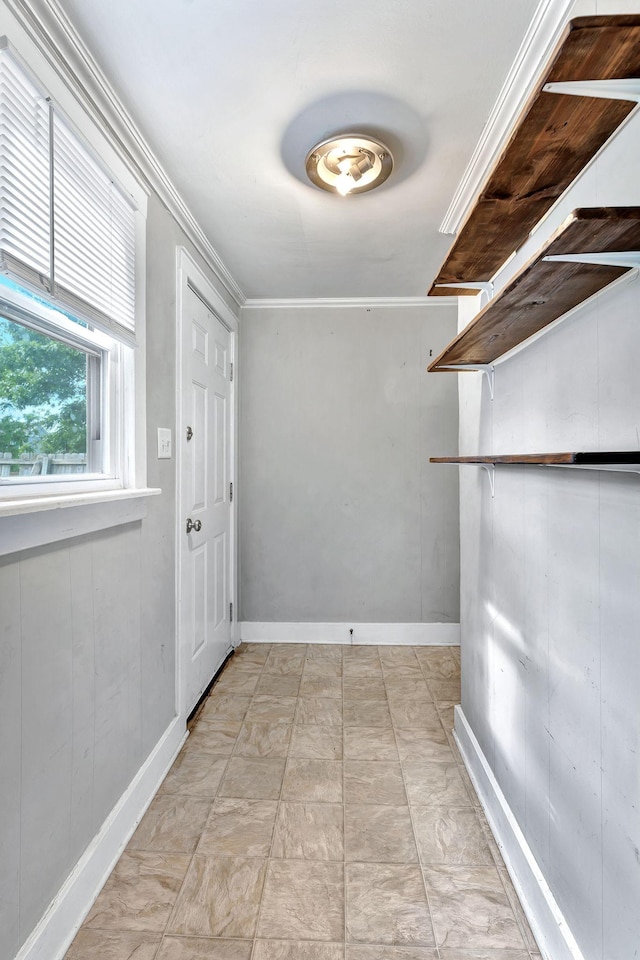 entryway featuring crown molding and baseboards