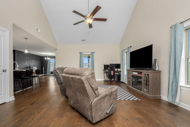 238 Spring Breeze Dr, Tullahoma, TN 37388 - living room with high vaulted ceiling, a ceiling fan, a glass covered fireplace, wood finished floors, and a chandelier