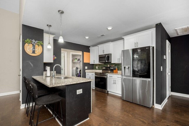 238 Spring Breeze Dr, Tullahoma, TN 37388 - kitchen with stainless steel appliances, a sink, baseboards, a peninsula, and white cabinets