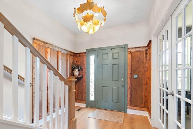 1125 Clendening Dr, Gallatin, TN 37066 - entrance foyer with a chandelier, light wood finished floors, stairs, and french doors