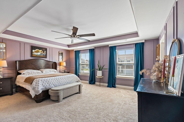 1125 Clendening Dr, Gallatin, TN 37066 - bedroom with a raised ceiling, light carpet, a decorative wall, and ceiling fan