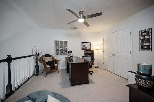 office space featuring a ceiling fan, light carpet, and lofted ceiling