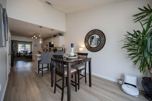 dining room featuring light wood-style floors and baseboards
