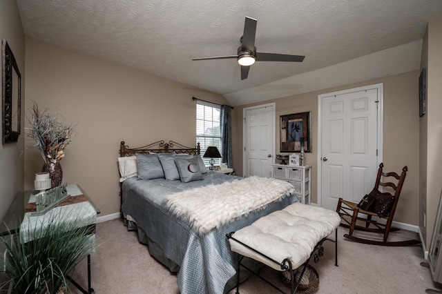 bedroom with light carpet, baseboards, a closet, a ceiling fan, and a textured ceiling