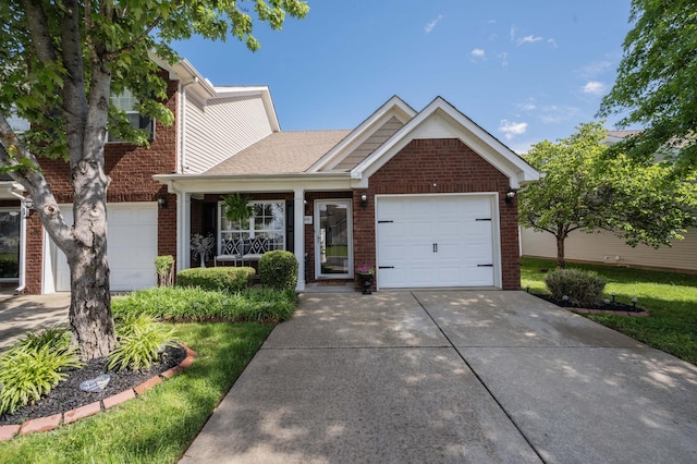 view of front of property with brick siding, driveway, and a garage