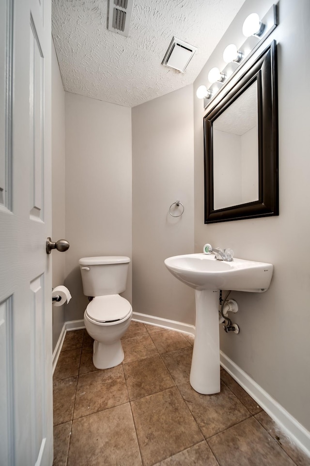 4838 Laura Jeanne Blvd, Murfreesboro, TN 37129 - bathroom featuring toilet, baseboards, tile patterned floors, and a textured ceiling