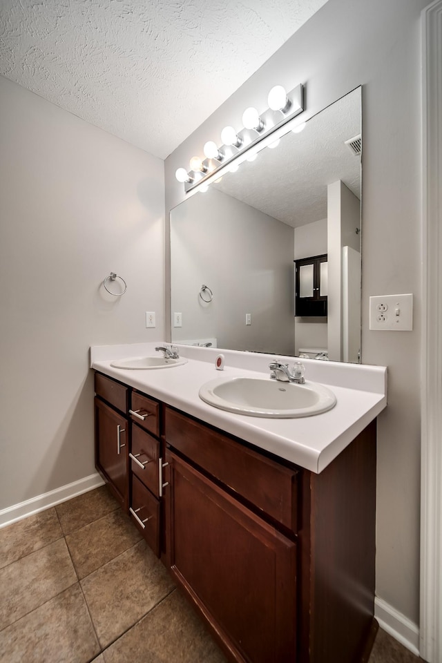 4838 Laura Jeanne Blvd, Murfreesboro, TN 37129 - bathroom featuring a textured ceiling, double vanity, tile patterned floors, and baseboards