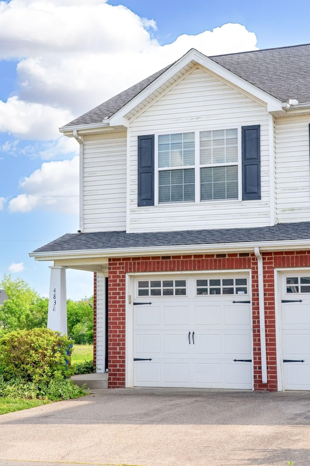 4838 Laura Jeanne Blvd, Murfreesboro, TN 37129 - view of front facade with an attached garage, brick siding, concrete driveway, and roof with shingles