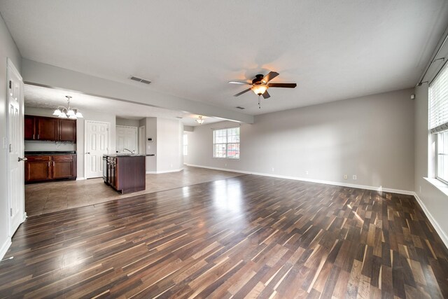 4838 Laura Jeanne Blvd, Murfreesboro, TN 37129 - unfurnished living room featuring dark wood-style flooring, ceiling fan, a chandelier, and baseboards