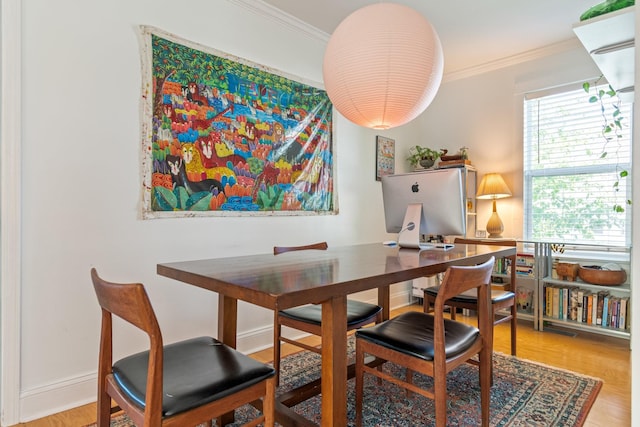dining room featuring ornamental molding, wood finished floors, and an office area