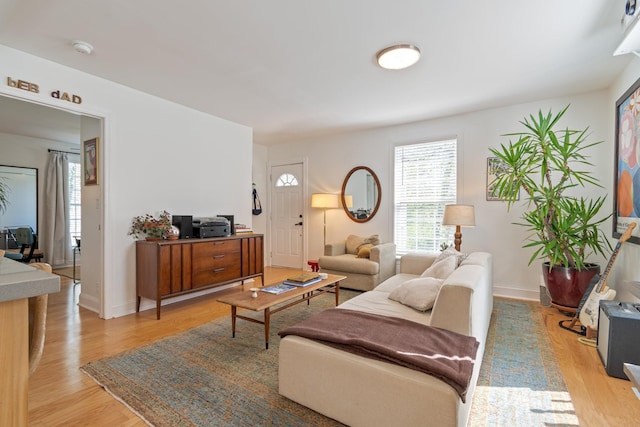 living room featuring light wood-style flooring and baseboards
