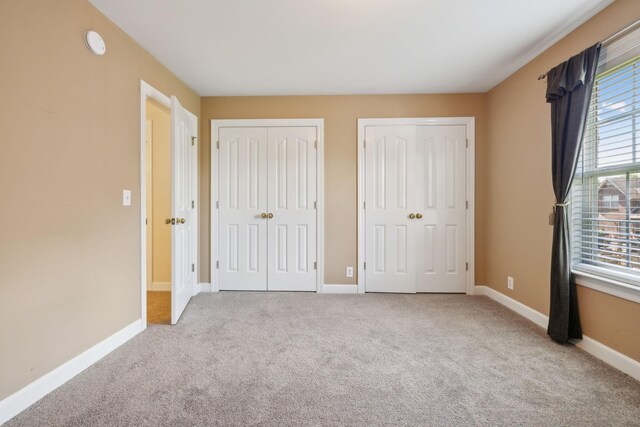 1403 Ottawa Pl, Murfreesboro, TN 37129 - unfurnished bedroom featuring two closets, carpet flooring, and baseboards
