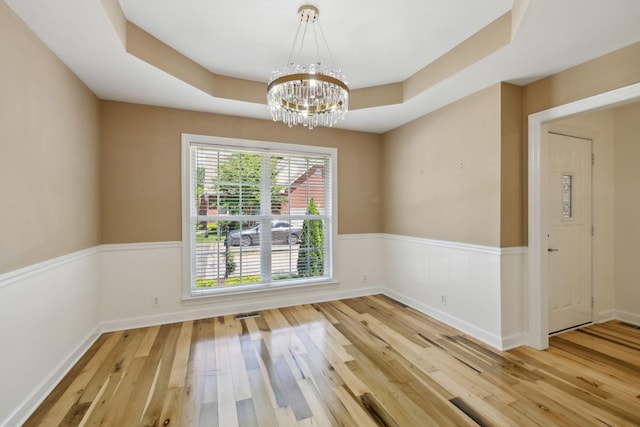 1403 Ottawa Pl, Murfreesboro, TN 37129 - spare room with wood-type flooring, a chandelier, a tray ceiling, and baseboards