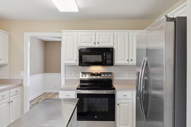 1403 Ottawa Pl, Murfreesboro, TN 37129 - kitchen featuring stainless steel appliances, white cabinets, light countertops, and light wood-style flooring