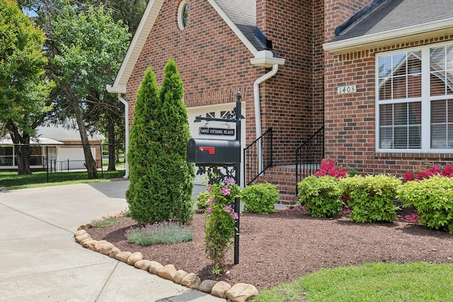 1403 Ottawa Pl, Murfreesboro, TN 37129 - view of property exterior featuring brick siding, fence, an attached garage, and concrete driveway