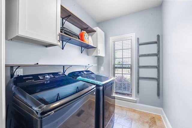 laundry area with cabinet space, independent washer and dryer, baseboards, and light tile patterned floors