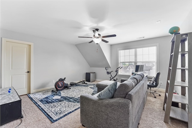 carpeted living area with ceiling fan, baseboards, a desk, and vaulted ceiling