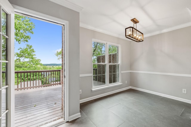unfurnished dining area with crown molding, a chandelier, baseboards, and tile patterned flooring