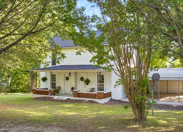 1885 N Soules Chapel Rd, Cunningham, TN 37052 - view of front of property featuring covered porch, a front lawn, a shingled roof, and a detached carport