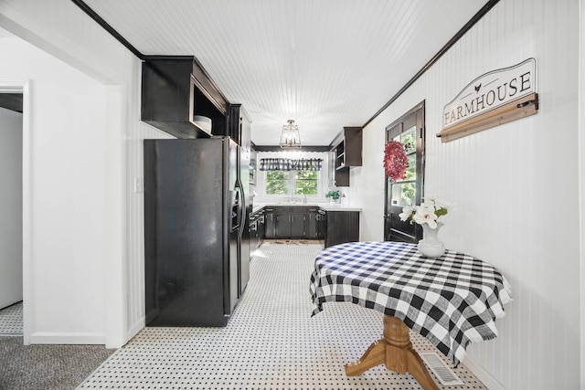 1885 N Soules Chapel Rd, Cunningham, TN 37052 - kitchen with black refrigerator with ice dispenser, light colored carpet, light countertops, a sink, and baseboards