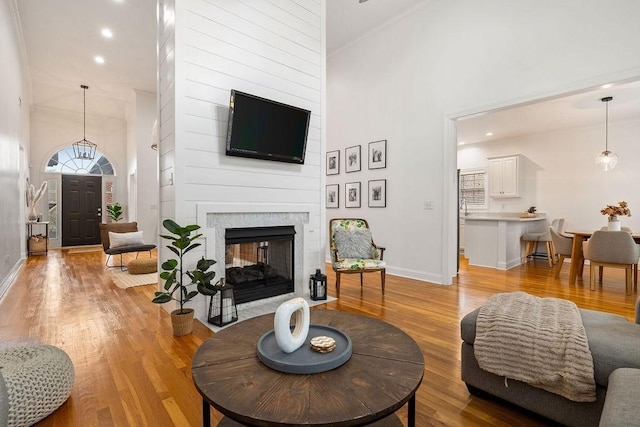2184 Loudenslager Dr, Thompsons Station, TN 37179 - living room with a high ceiling, baseboards, light wood-type flooring, a multi sided fireplace, and recessed lighting