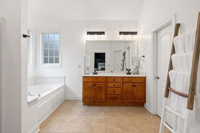 2184 Loudenslager Dr, Thompsons Station, TN 37179 - bathroom featuring a garden tub, double vanity, tile patterned floors, and baseboards