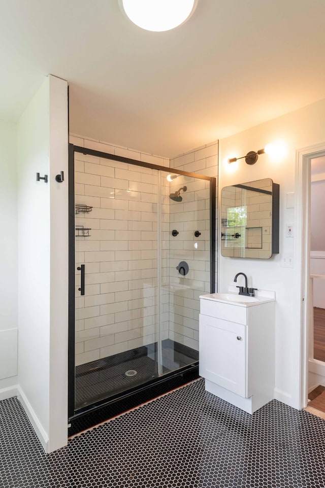 2219 Blair Blvd, Nashville, TN 37212 - full bath featuring a stall shower, baseboards, vanity, and tile patterned floors