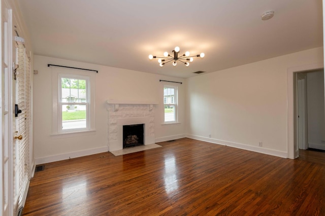 2219 Blair Blvd, Nashville, TN 37212 - unfurnished living room featuring healthy amount of natural light, wood finished floors, a chandelier, and baseboards