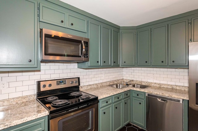 2219 Blair Blvd, Nashville, TN 37212 - kitchen featuring stainless steel appliances, a sink, decorative backsplash, and green cabinetry