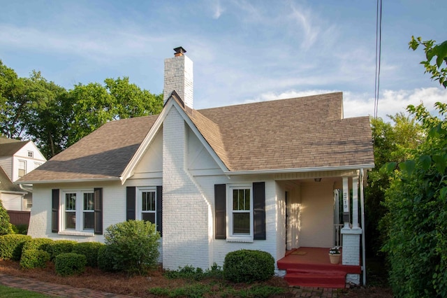 2219 Blair Blvd, Nashville, TN 37212 - view of front of house featuring brick siding, a chimney, and roof with shingles