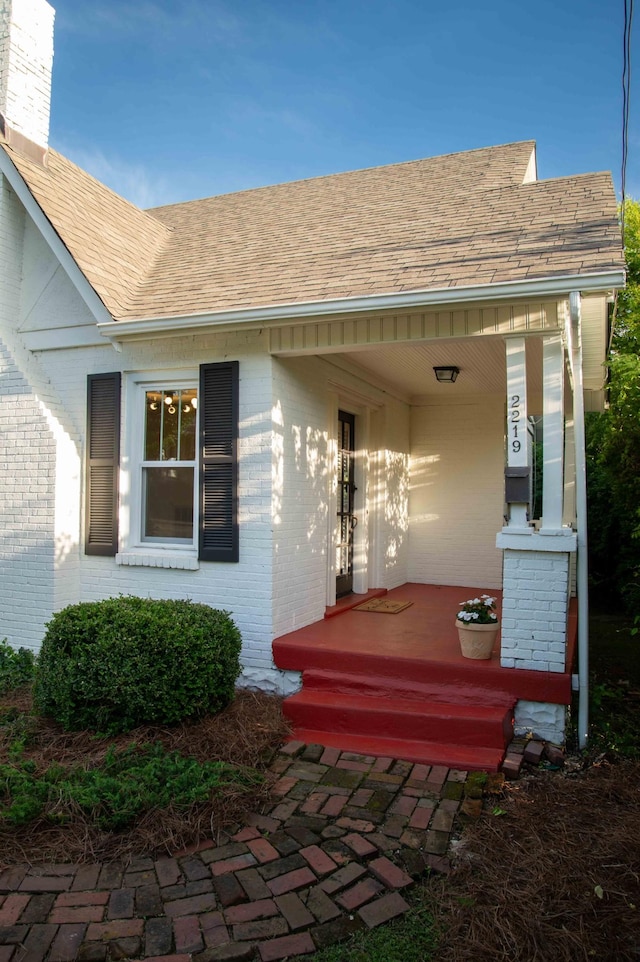 2219 Blair Blvd, Nashville, TN 37212 - entrance to property featuring brick siding, a shingled roof, and covered porch
