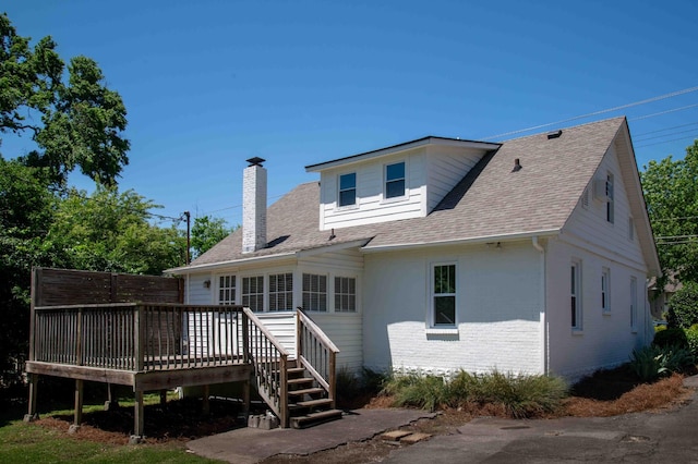 2219 Blair Blvd, Nashville, TN 37212 - rear view of property featuring a chimney, a deck, brick siding, and roof with shingles