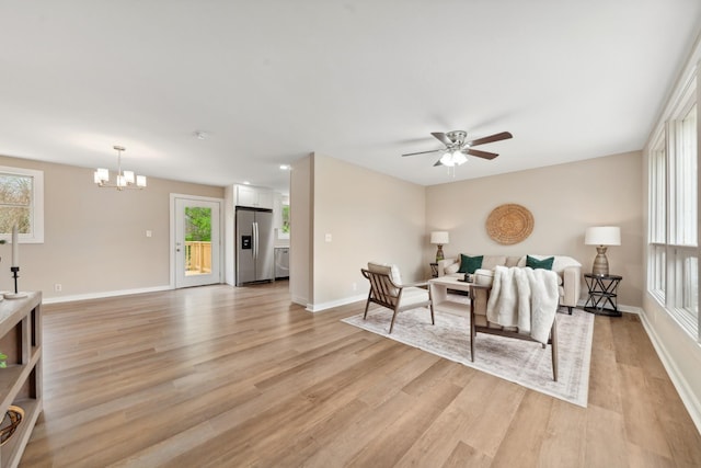 1614 Shady Cir, Lebanon, TN 37087 - living room featuring light wood finished floors, healthy amount of natural light, and a chandelier