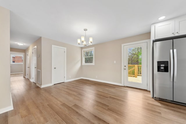 1614 Shady Cir, Lebanon, TN 37087 - unfurnished dining area featuring plenty of natural light, baseboards, and light wood-type flooring