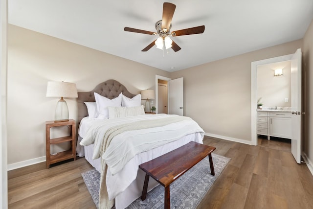 1614 Shady Cir, Lebanon, TN 37087 - bedroom featuring baseboards, light wood-style floors, a sink, and ensuite bath