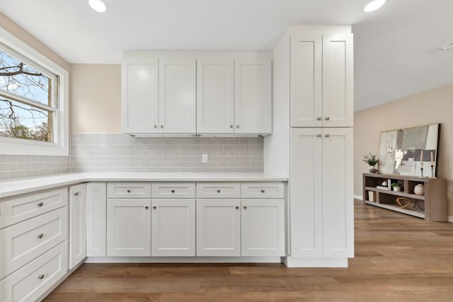 1614 Shady Cir, Lebanon, TN 37087 - kitchen featuring white cabinets, light countertops, backsplash, light wood-style floors, and recessed lighting