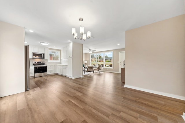 1614 Shady Cir, Lebanon, TN 37087 - unfurnished dining area with a chandelier, light wood finished floors, baseboards, recessed lighting, and a ceiling fan