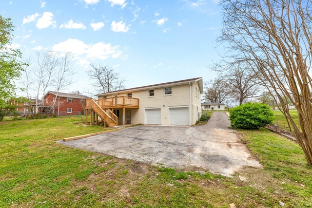 1614 Shady Cir, Lebanon, TN 37087 - back of property featuring stairs, a garage, driveway, a wooden deck, and a lawn