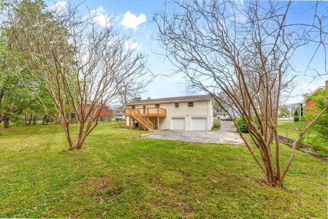 1614 Shady Cir, Lebanon, TN 37087 - rear view of house featuring stairway, an attached garage, a wooden deck, stucco siding, and driveway