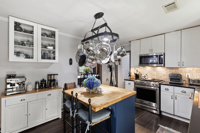 1515 Owen Rd, Brentwood, TN 37027 - kitchen featuring appliances with stainless steel finishes, wood counters, ornamental molding, dark wood finished floors, and decorative backsplash