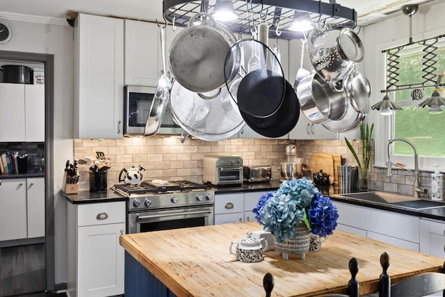 1515 Owen Rd, Brentwood, TN 37027 - kitchen with butcher block counters, a sink, decorative backsplash, stainless steel appliances, and plenty of natural light