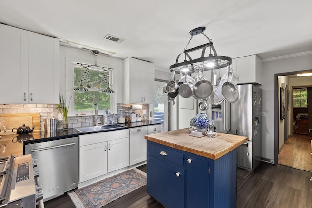 1515 Owen Rd, Brentwood, TN 37027 - kitchen with stainless steel appliances, wooden counters, a sink, blue cabinetry, and backsplash