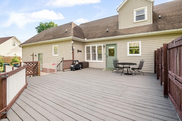 wooden deck featuring outdoor dining area