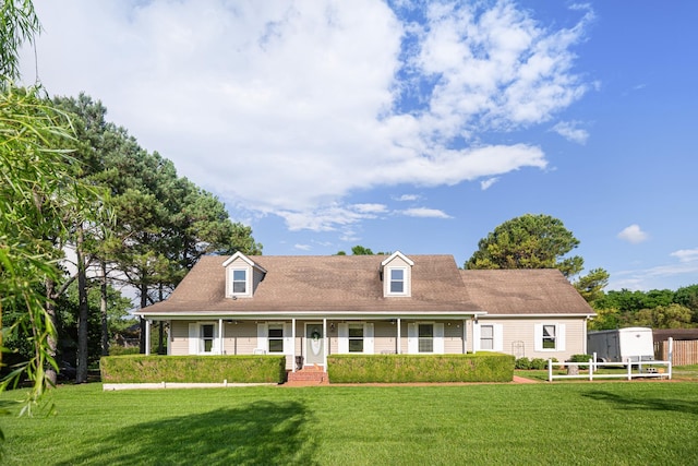 cape cod home with a front lawn and covered porch