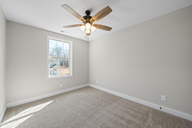carpeted spare room with baseboards and ceiling fan