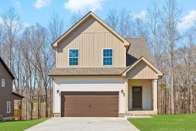 view of front of property with a shingled roof, a garage, a front yard, driveway, and board and batten siding