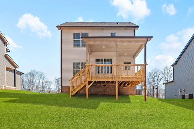 rear view of house featuring a deck, a lawn, and stairs