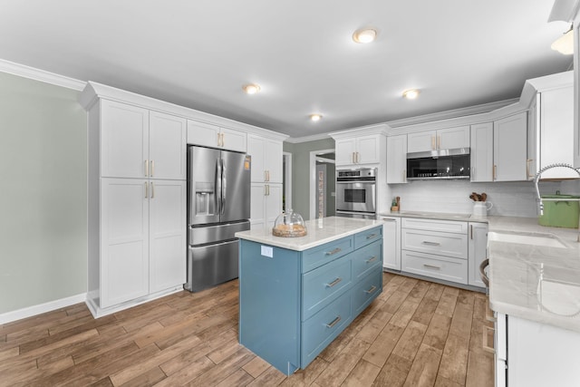 707 Bradford Pl, Murfreesboro, TN 37130 - kitchen with appliances with stainless steel finishes, blue cabinetry, white cabinetry, a sink, and crown molding